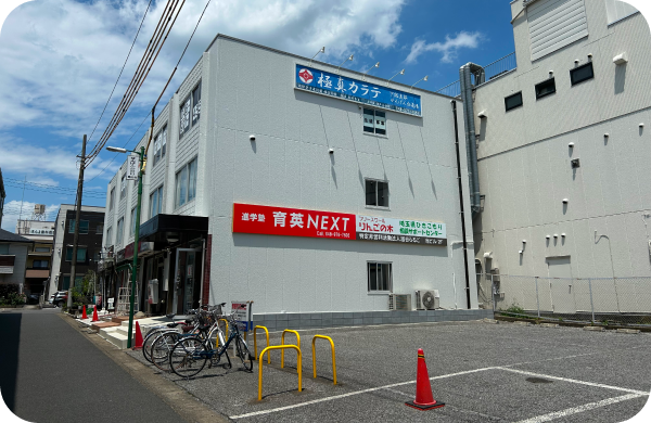 駐車場の隣に2階建てのビル